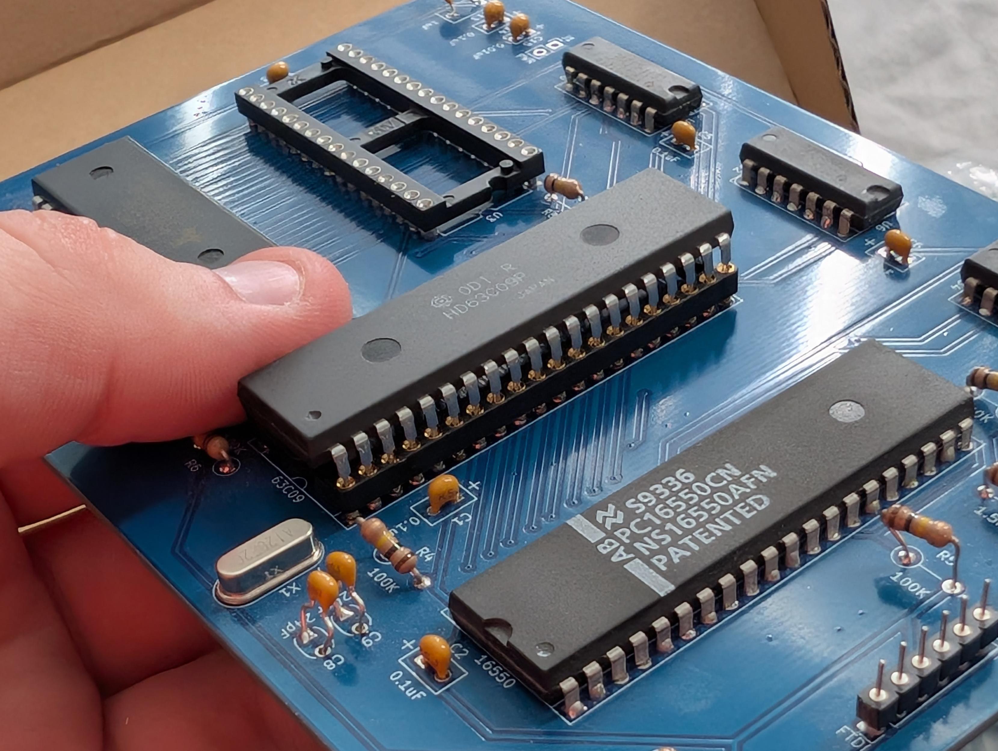 a chibi pc09 prototype board, soldered with some ICs in sockets. one socket is empty
