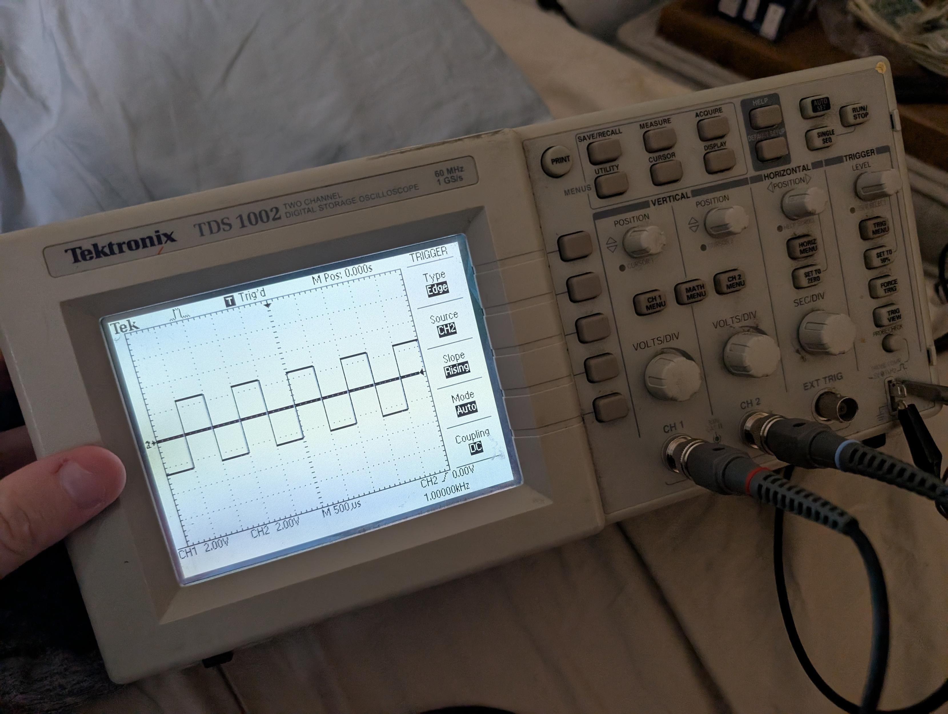the scope probes being calibrated, the display shows a square wave