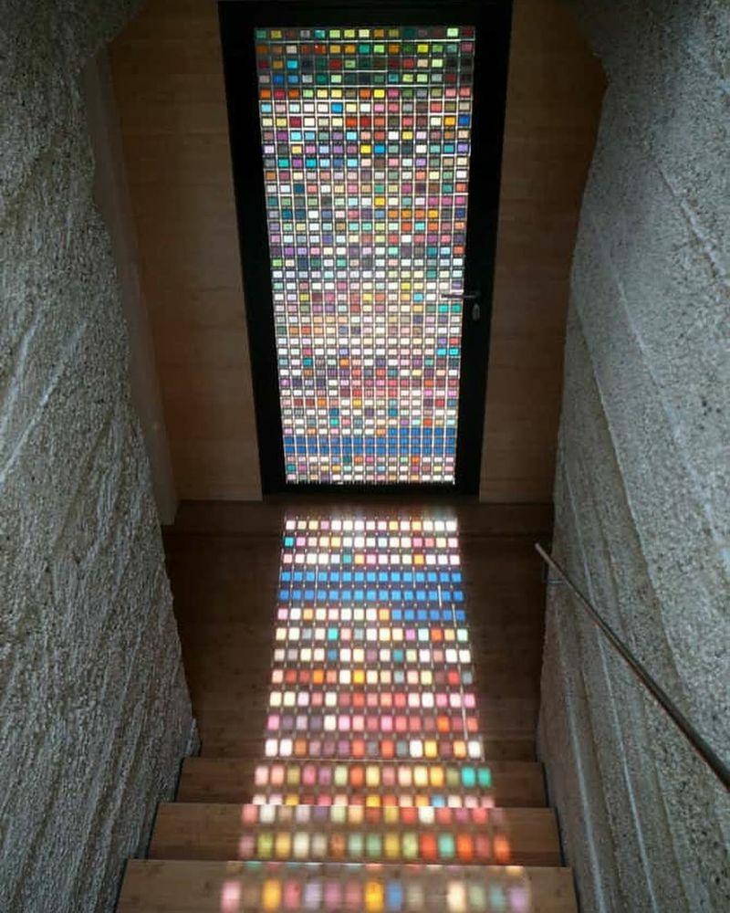 A stained glass door by architect Armin Bassbichler but actually made out of hundreds of 1x1 inch pantone swatches in multiple colors