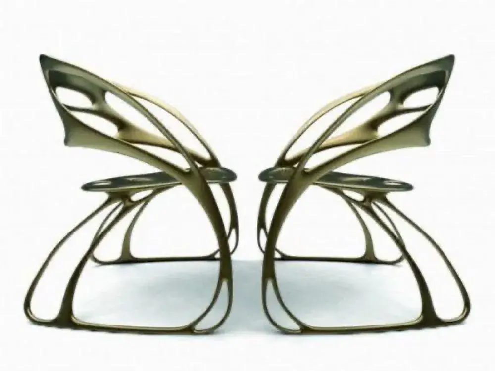 When two chairs are placed side-by-side facing each other, their flowing organic contours combine to recreate the complete, literal silhouette of a butterfly.